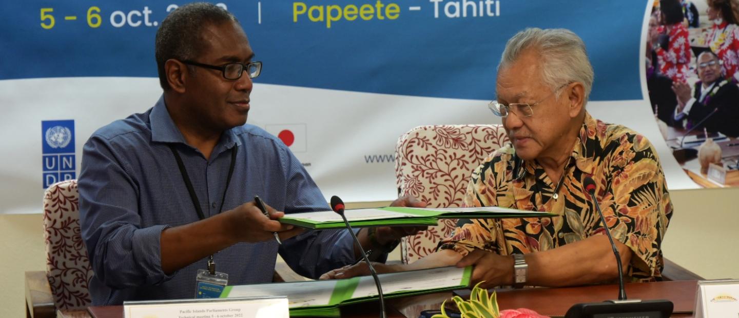 Hon. Peter Kenilorea Jnr (Left) & Mr Gaston TONG SANG (Right) President of the Assembly of French Polynesia exchange the signing documents.